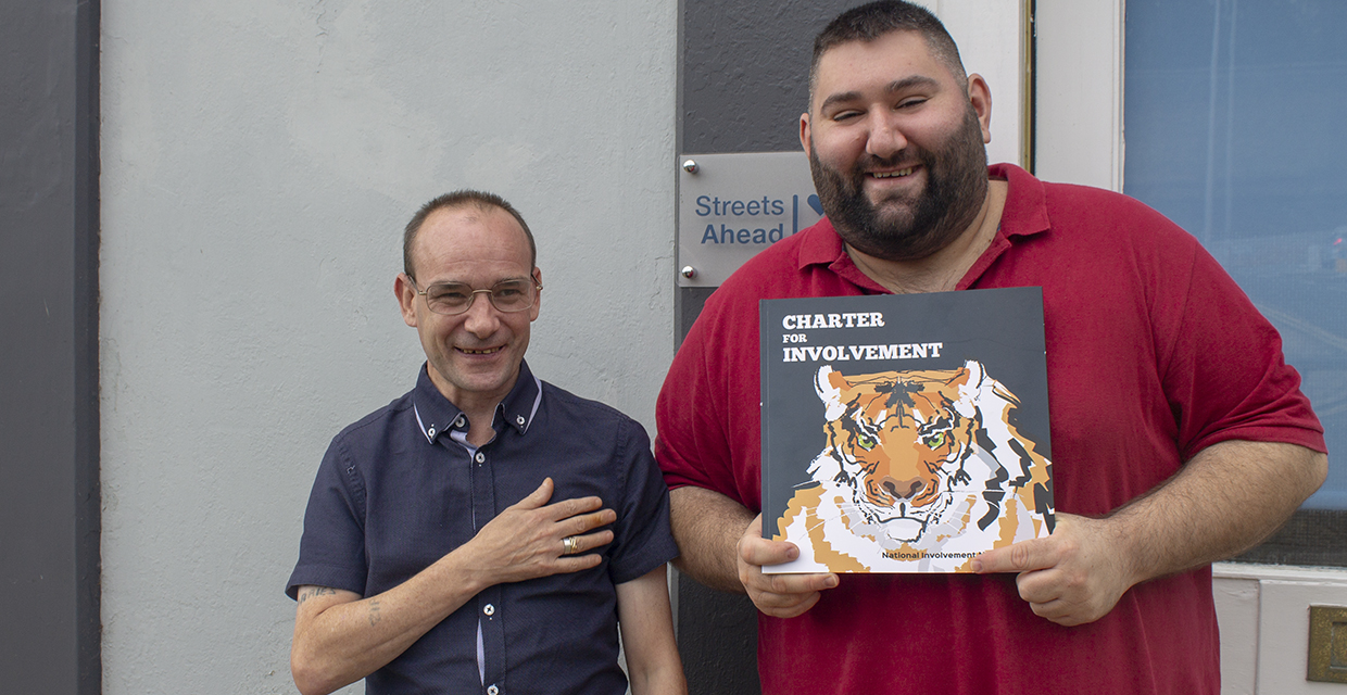 James and David holding the Charter for Involvement